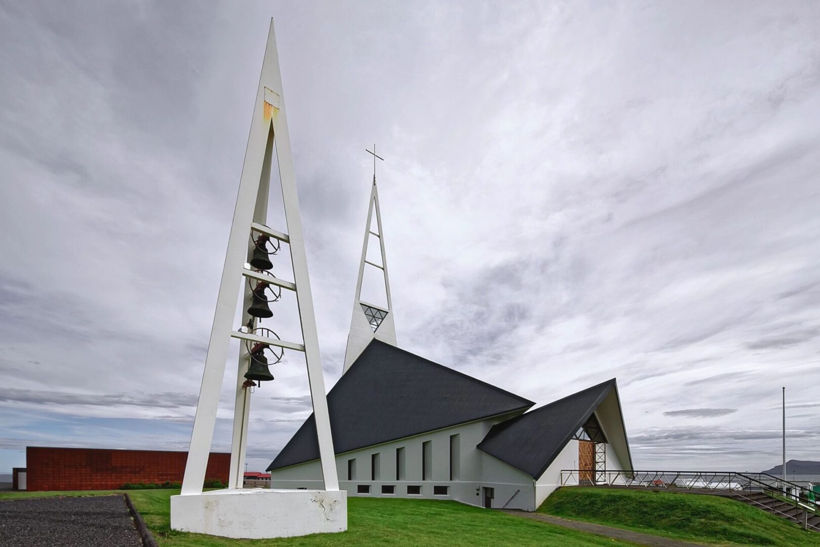 A church with two bells on the top of it